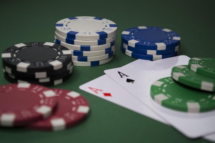 A poker table with cards and chips
